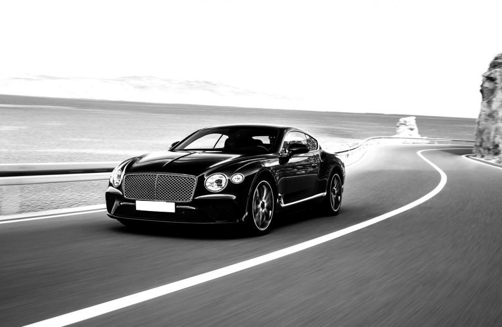 Aurum - high net-worth Bentley car driving on the road